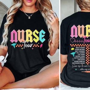 May include: Black t-shirt with a colorful "Nurse Tour" graphic. The back of the shirt features a list of tasks nurses perform, including "Multi Tasking", "Scrub Wearin", "Shift Changin", "Pill Slingin", "Life Savin", "Patient Lovin", "Coffee Drinkin", "Evaluatin", "Blood Samplin", "Difference Makin", "Stethoscope Swingin", "Syringe Wieloin", "Heart Monitor Watchin", "Glove Snappin", "Pulse Checkin", "Thermometer Wipin", "Scrub Pocket Stuffin", "Hand Sanitizer Pumpin", "Glove Box Stockin", and "Patient Chart Sortin". The text reads "Some days we rock it, some days it rocks us, either way we're rockin".