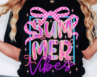 May include: Black t-shirt with the words "SUMMER Vibes" in a colorful, playful design. The text is outlined in pink and purple, with a blue square border and pink bows. A fun, summery graphic tee.