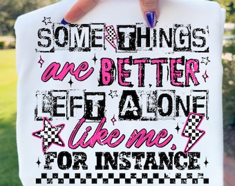May include: White t-shirt featuring the text "SOME THINGS are BETTER LEFT ALONE like me. FOR INSTANCE" in black and pink. The design incorporates stars, lightning bolts, and checkered flag motifs.
