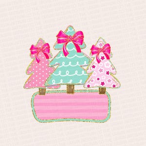 May include: Three pink and green Christmas trees with pink bows and gold glitter trim, sitting on a pink and gold striped banner.
