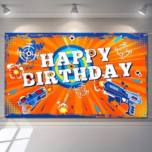 May include: Orange and blue birthday banner with the words "Happy Birthday" in white letters. The banner features a target with a blue bullseye and a red and blue toy gun.