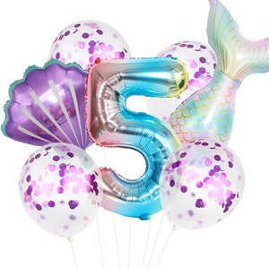 May include: A set of mermaid-themed party balloons, including a large iridescent number 5 balloon, a purple seashell balloon, a mermaid tail balloon, and four clear balloons with purple confetti.