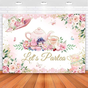May include: Pink and gold 'Let's Partea' party backdrop with a teapot, teacups, flowers, and cupcakes.