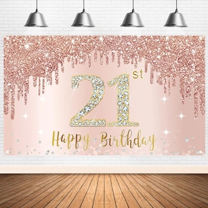 May include: A pink and gold glitter backdrop with the number 21 decorated with rhinestones and the text "Happy Birthday" in gold lettering. The number 21 has a "st" superscript.