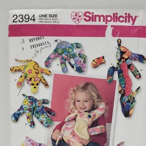 May include: A sewing pattern for making stuffed animals. The pattern includes instructions for making a variety of animals, including a unicorn, an elephant, a giraffe, and a rhino. The pattern is from Simplicity and is for one size. The pattern is called "Sonja's Snuggables".