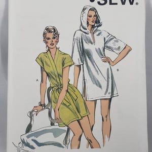 May include: A Kwik Sew pattern envelope for pattern 1222, featuring illustrations of two garments: a yellow wrap-style robe with short sleeves and a white hooded tunic with short sleeves and side slits. The text includes Pattern 1222, Sizes XS-S-M-L, and Kwik Sew Pattern Co. Inc. 3000 Washington Ave. North Minneapolis, MN 55411-1699 U.S.A.