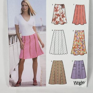 May include: Simplicity sewing pattern 5199 for six skirt styles in sizes 14, 16, 18, and 20. The package features illustrations of various skirt designs including floral, polka dot, and solid patterns with different waist and pocket details.