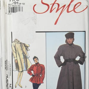May include: A white paper sewing pattern envelope labeled Style 1152 size HH (6-12). The front displays illustrations of three coat styles: a long beige coat, a red belted jacket, and a long dark grey coat with a matching hat and black gloves.