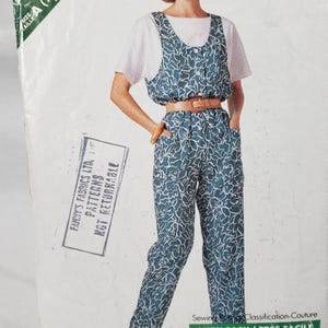 May include: Butterick pattern 4190/836 for a jumpsuit. The jumpsuit is teal with a white floral design, worn with a white top and brown belt. The pattern is for sizes XS-XL. Sewing pattern.