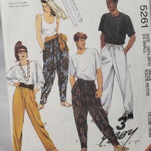 May include: McCall's sewing pattern 5261 featuring illustrations of various outfits, including pants and tops. The pattern includes the text "FABRICLAND NO EXCHANGING REFUND" and size information.