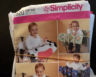 Simplicity 2920 sewing pattern for baby grocery cart cover, pattern is cut, neat and pressed, one size and comes with fabric pieces