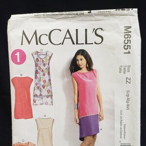 May include: A sewing pattern for a sleeveless dress with a colour-blocked design. The pattern is for sizes large, extra large, and extra extra large. The pattern is from McCall's and the pattern number is M6551.