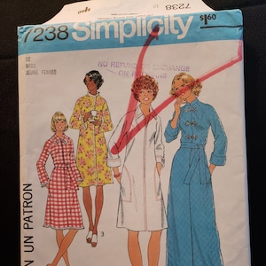 May include: Simplicity sewing pattern number 7238 for a miss's robe. The pattern includes four different styles of robes, including a white robe with a shawl collar, a blue robe with a sash, and a floral robe with a shawl collar. The pattern is for sizes 12.