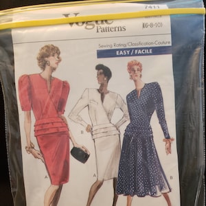 May include: A sewing pattern for three dresses. The pattern is for sizes 6-8-10 and is rated easy. The dresses are shown in red, white, and blue with polka dots.