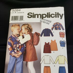 May include: Simplicity sewing pattern number 5284 for sizes 3-8. The pattern includes instructions for making a variety of children's clothing, including a jacket, a skirt, a dress, a shirt, and pants. The pattern is illustrated with a boy and girl wearing the finished garments.