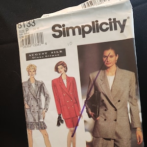 May include: A Simplicity sewing pattern for a double-breasted blazer and shorts. The pattern is for sizes 12-18 and is designed by August Silk, Diane Gilman. The pattern shows three different models wearing the blazer and shorts in different colors and fabrics.