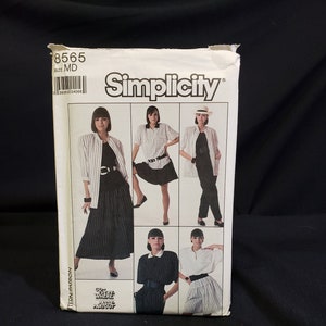 May include: Simplicity sewing pattern number 8565, size MD, for a shirt and skirt. The pattern shows five different styles of the shirt and skirt, all in black and white.