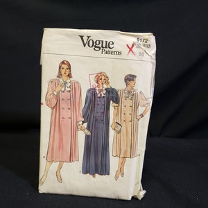 May include: Vogue Patterns sewing pattern number 9172 size 10 for a dress with long sleeves and a collar. The pattern shows three different styles of the dress in pink, blue, and beige.