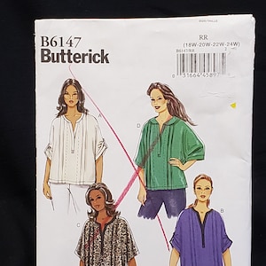 May include: A Butterick sewing pattern, B6147, showing illustrations of four tunic tops in white, green, leopard print, and purple. The pattern includes sizes 18W-24W. The pattern is for sewing clothing.