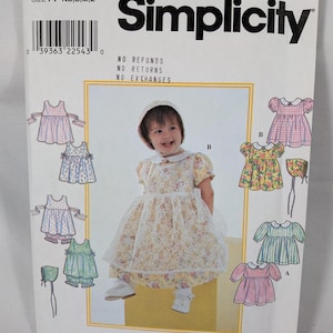 May include: A Simplicity sewing pattern envelope 8538 for infant clothing in sizes NB, S, M, and L. The cover features illustrations and a photograph of dresses with collars, short sleeves, and matching bonnets in various floral and striped prints.