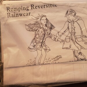 May include: A black and white illustration of two children wearing raincoats. The text "Romping Reversible Rainwear" is at the top of the image.
