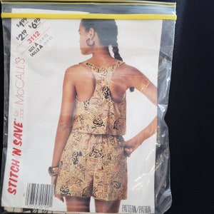 May include: A sewing pattern for a sleeveless top and shorts set. The pattern is for sizes 6-8-10 and is from McCall's Stitch 'N Save line. The pattern features a geometric print in shades of brown, yellow, and black.