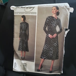 May include: A black and white polka dot dress pattern with a V-neckline and long sleeves. The pattern is for sizes 6-8-10-12-14. The pattern is by Rachel Comey, a Vogue Patterns American Designer.