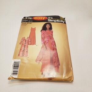 May include: A sewing pattern for a long dress with a floral print. The pattern is for sizes 10-20 and includes a long dress with a matching jacket. The pattern is from Simplicity and is labeled "It's So Easy".