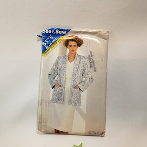 May include: A vintage sewing pattern envelope for a jacket and skirt. The pattern is for sizes 8-10-12 and is available in large sizes. The pattern is from Fabricland and is for a blue and white floral print jacket and a white skirt.