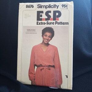 Peut inclure: Patron de couture Simplicity numéro 8676, intitulé "ESP Extra-Sure Pattern", pour une robe à manches longues avec un col en V et une ceinture à nouer. Le patron est conçu pour les tricots extensibles uniquement et comprend des méthodes de tricot extensible Time Saver.