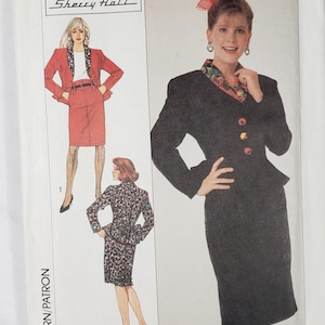 May include: Simplicity sewing pattern 9314 featuring a skirt suit and a dress. The pattern includes illustrations of the designs and the name "Sherry Halt". The pattern size is N (10+12+14).