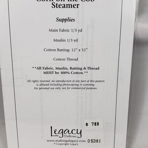 May include: A sewing pattern for a Corn on the Cob Steamer, including fabric, muslin, batting, and thread. The cotton batting measures 30.48 cm x 81.28 cm. The text "Legacy Patterns" is visible on the package.