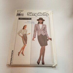 May include: Simplicity sewing pattern number 8797 for a skirt and jacket. The pattern is for size 14. The pattern shows a woman wearing a gray jacket and a brown skirt. The pattern also shows a woman wearing a white blouse and a brown skirt.