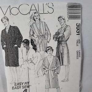 May include: A McCall's 3931 sewing pattern envelope for robes in size Large. The front features black and white illustrations of four individuals wearing different robe styles, with text including Easy Fit, Easy Sew, and 4 Pieces.