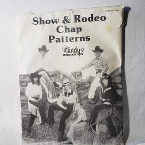 May include: A vintage black and white Tandy Leather Company pattern booklet titled "Show & Rodeo Chap Patterns." The cover features images of people in cowboy hats and chaps. Stock No. 2665 is printed on the top right corner.