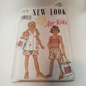 May include: A sewing pattern for kids clothing, featuring two girls wearing different outfits. The pattern is called "New Look...for Kids" and includes a white top with floral shorts and a red and white gingham top with floral shorts.