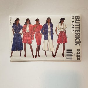 May include: A sewing pattern for four different outfits. The pattern is from Butterick Classics and is size 6-10. The outfits include a jumpsuit, a skirt and shorts set, a dress, and a pants and jacket set. The pattern is printed on white paper with black and red text.