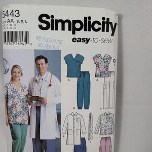 May include: A Simplicity 5443 sewing pattern envelope for medical scrubs and a lab coat. The front displays illustrations of V-neck tops, trousers with pockets, and a long-sleeved lab coat. Text includes Simplicity, easy-to-sew, and size AA S, M, L.