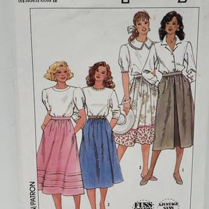 May include: Simplicity sewing pattern number 9593 for sizes HH (6-12) or EUR. HH (34-40). The pattern includes instructions for making four different skirts. The skirts are shown on four women wearing white tops. The skirts are a pink skirt with ruffles, a blue skirt, a floral print skirt, and a brown skirt.