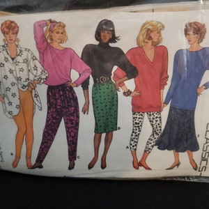 May include: A sewing pattern for five different women's tops. The pattern includes a guide to overlock sewing. The pattern is for sizes 6-8-10.