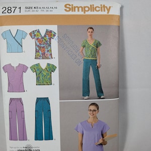 May include: Simplicity sewing pattern 2871 for tops and trousers in sizes K5 8, 10, 12, 14, 16. The envelope displays illustrations of various scrub-style tops with V-necks and wrap designs, along with matching straight-leg trousers in solid and floral prints.