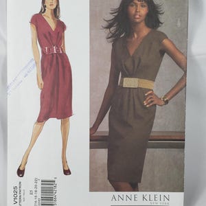 May include: A sewing pattern envelope for an Anne Klein Vogue American Designer dress, model V1025, size E5 (14-16-18-20-22). The cover features a sketch and a photograph of a V-neck dress with cap sleeves and a wide belt, presented in a dark color.