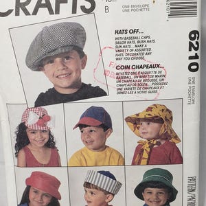 May include: McCall's Crafts pattern featuring various hat styles, including baseball caps and sun hats. The image shows children modeling different hat designs. The pattern offers options for creating assorted hats.