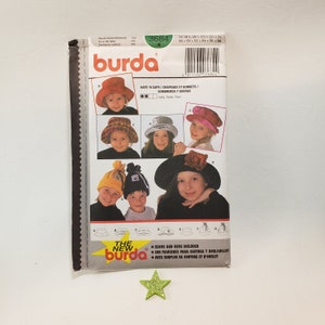 May include: Burda sewing pattern number 3684 for hats and caps. The pattern includes six different styles of hats, including a wide-brimmed sun hat, a newsboy cap, and a beanie. The pattern is printed on a white background with black text and illustrations.