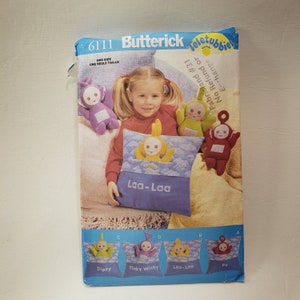 May include: A sewing pattern for making Teletubbies plush toys. The pattern includes instructions for making four different Teletubbies: Dipsy, Tinky Winky, Laa-Laa, and Po. The pattern is from Butterick and is size 6111.
