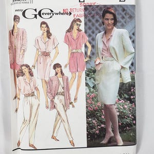 May include: A Simplicity sewing pattern envelope for a Go Everywhere collection featuring illustrations of blazers, shirts, skirts, and trousers. The cover displays various outfits in pink, white, and plaid, with a barcode and size 12-18 label.