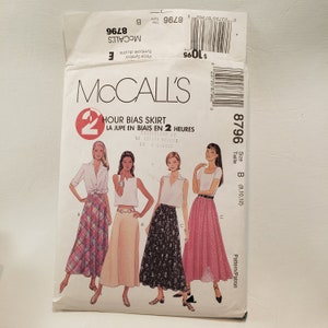 May include: A sewing pattern for a skirt with a 2-hour bias construction. The pattern is for sizes 8, 10, and 12. The pattern shows three different styles of skirts, one with a plaid pattern, one with a floral pattern, and one with a polka dot pattern.