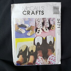 May include: McCall's Crafts sewing pattern for a pair of dog-shaped slippers. The pattern is for a one-envelope pattern, and the pattern number is 3471.