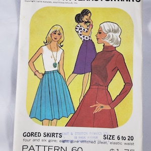 May include: A vintage Kandel Patterns for Knits envelope featuring three illustrated figures wearing gored skirts. The text reads Gored Skirts, Pattern 60, Size 6 to 20, and From a Professional Knitting Mill. The background is a pale yellow rectangle.