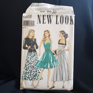 May include: A sewing pattern for three dresses. The pattern is from New Look and has the number 6058. The dresses are all in a polka dot pattern, with one dress in black and white, one in green and white, and one in white and black. The pattern includes instructions for sizes 6-16.